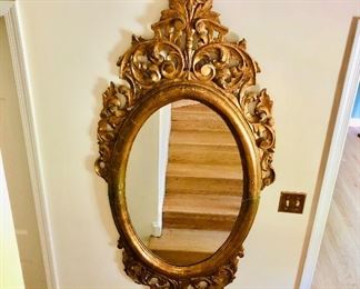 $450 Oval Louis XV style gold leaf mirror with plume and scroll with pediment and shell carving at the base  67" high by 32" wide 