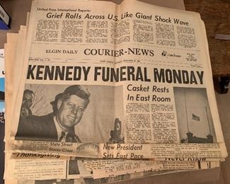 About a dozen Kennedy news papers 
