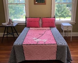 iron bed, bedding, night tables, rug, oil painting