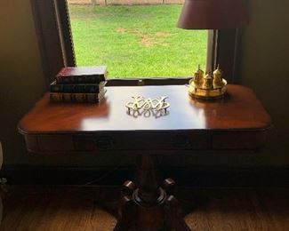 console table, desk lamp, fake book  boxes, brass Williamsburg trivet
