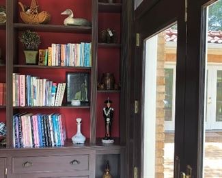 books, duck decoy tiny churn,military soldier decanter,crock, antique china doll in basket, planter, milk glass decanter, brass school bell, decorative finial