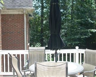 Patio table with 4 chairs and umbrella and stand