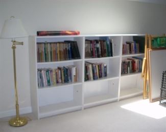 3 bookcases and books, floor lamp