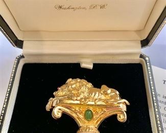 $50 Detail: Second view.  Ann Hand “The Corcoran Lion”  gold tone with green cabachon pin. 2”H x 2”W