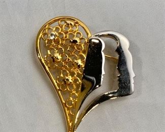 $25 Tal Salomon, signed, gold and silver tone and rhinestone heart and face pendant/brooch. 2"H x 1.5"W
