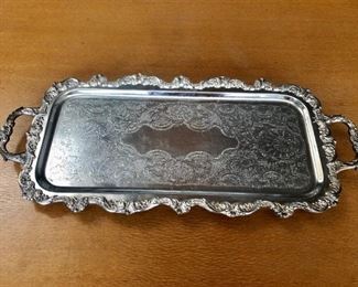 $95 Silver plate footed serving tray with handles. 23.5”L x 10.5”W
