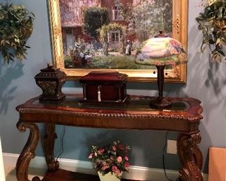 Glass top console table, great art work throughout the house.