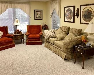 Two spice colored chairs, gold sofa, cherry side table