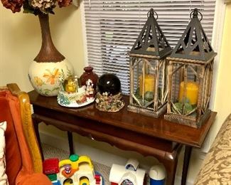 Cherry console table, 2 wooden lanterns with candles, tall painted vase, Little Tikes and Fisher Price toys