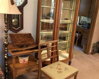 Curved front curio cabinet, lamp, clock chair, end table