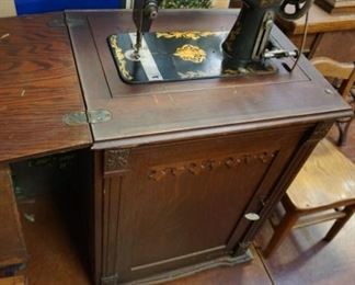 vintage sewing machine in nice wood cabinet