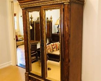 Two door mirrored gold leaf trimmed clothes armoire with 3 drawers