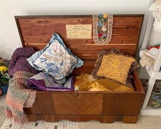 Cedar chest with pillows and throws
