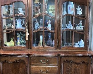 Another china cabinet with figurines and knick knacks