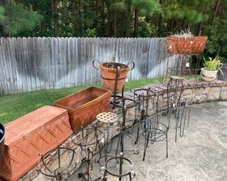 Many planters and plant stands