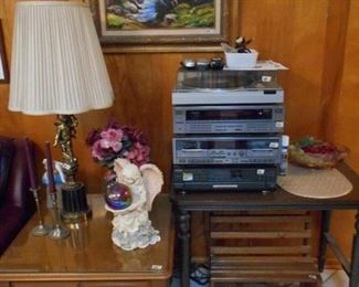 turntable by Panasonic, DVD player by JVC, cassette player by JVC, table, small bench, side table with glass top,  angel lamp, etc.