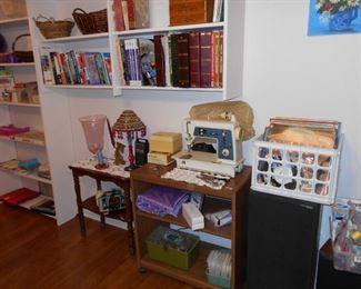 records, Singer sewing machine, TV stand, small table, books, baskets, jewelry boxes, books, games, CD's, DVD's, etc.
