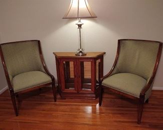 A pair of amazing green side chairs, lighted curio sidebar, beautiful modern lamp