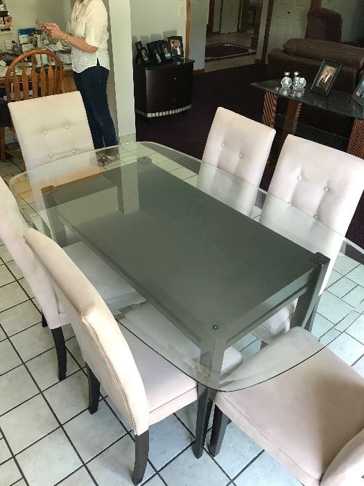 Glass top dining room table with six matching chairs