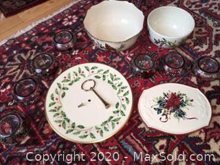 An assortment of Lenox Winter Greetings serving pieces and candle holders