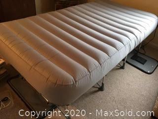 Easy storage portable Frontgate blow-up bed on frame.
