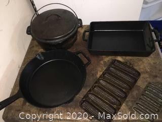 Artisanal cast iron skillet and square pan. Covered Dutch Oven and two corn bread pans