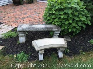 Two concrete garden benches.