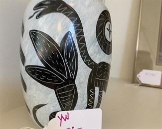 A Kosta Boda, Ulrica Hydman Vallien designed vase. Features a white base hue, garnished with black hued abstract motifs of animals and visages. Stickered:"Kosta Boda" and signed:"Ulrica HV/ES". 8"T