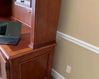 #29	inlay burl wood desk with file drawer, 3 drawers, 2 pull out writing desk cpu cabinet (door needs screws, Hutch with 2 drawers, 2 doors with shelf, open glass shelf in middle, it has a decortive side design and carved wood collums  65x25x30-76	 $375.00 
