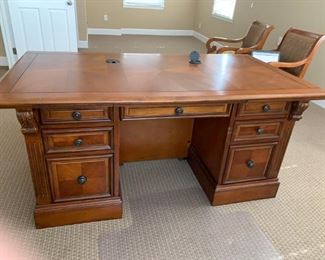 #37	arts and craft style desk with wood inlay top 8 drawers including 2 legal size file drawers carved colums on drawer side and decortive side, and 2 leading glass door cabinet and shelf on front. 66x36x30 has usb ports,SDSDHC MSPRO/DUO and ear phone plug on top 	 $600.00 
