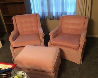 1 swivel and 1 stationary pink chairs with an ottoman