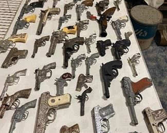 dozens of vintage cap guns - hubley - kilgore - star - cast iron ones - and more