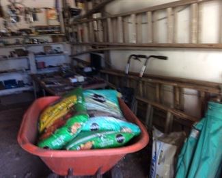 WHEELBARR SEVERAL BAGS OF GARDEN SOIL-GOLF CLUBS MANY HAND TOOLS