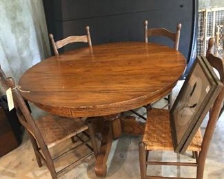 Round Oak table with four ladder back chairs