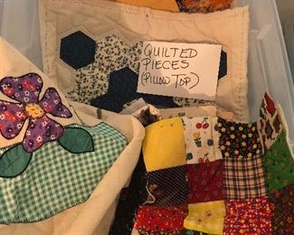 Box of quilted pieces for pillow top or other projects