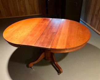 $495 Vintage oval pedestal table with two leaves (each 9" W).  59.5" W (fully extended), 42" D, 30" H.   With leaves removed, the table is round (41.5" diam).