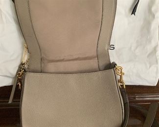 $125  Gently used Marc Jacobs Nomad pebbled leather cross body. Retails for $450 at Nordstrom website. A truly beauty and versatile color year round  - includes dust cover 
Color: MINK
11 ½"W x 9"H x 4 ½"D. (Interior capacity: small.)
19 1/2" - 23 1/2" crossbody strap drop.
2.4 lbs.
Hidden magnetic snap-flap closure
Optional, adjustable crossbody strap
Exterior zip and slip pockets
Interior zip, wall and smartphone pockets
Lined
#Leather