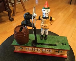 Trick Dog cast iron...put coin in dogs mouth, hit the side lever and he deposits it into the barrel.  
