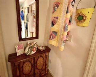 Small Wooden 2-Door Hand-Painted Cabinet and a Yellow Handmade Fan Quilt