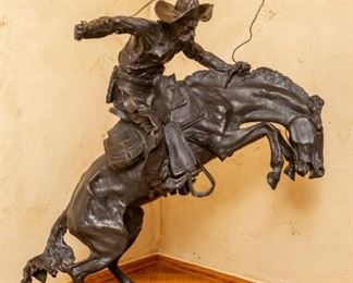 Lot #5 — Bronco Buster by Frederick Remington — Base is 17.5" Wide x Base is 10" Deep. Top of Cowboy Hat is 23" Tall. Rope is a Bit Taller.
