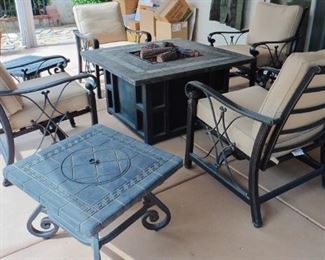Seville Fire Pit Patio Table with four chairs and cushions in great condition-ready to go. Chairs have rocking motion when seated. Ice bucket side tables to keep your beverages nice and cold. 