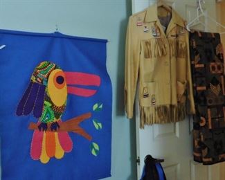 Colorful wall hanging; 1950’s Native American jacket; bed covers.