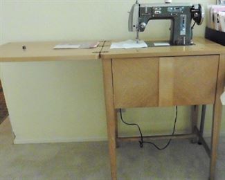 Universal sewing machine in 1950’s blonde  wood cabinet