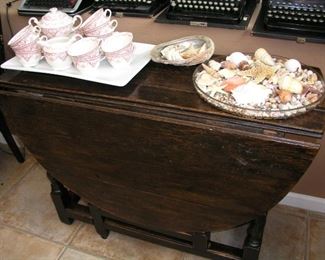 Item 106:
A) Antique Dark Oak Drop Leaf Table - 39" wide x 16" deep folded down - each drop side is 18" - Total size when open is 39" x 52" - 27.5" tall - Asking Price $79.00
B) Vintage China - 30 pieces - Swinnerton's "Kent" Staffordshire England - Asking Price $59.00
C) 14" Tray of Misc. Beautiful Shells - Asking Price $35.00
D) Abilone Shell with Sea Shells - Asking Price $25.00
