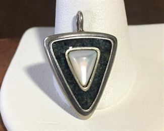 Carolyn Pollack Relios small pendant/charm with dark green crushed stone inlay and a mother of pearl triangular-shaped cabochon. Size 3/4" wide by 1" high (including bale). Signed with the crescent moon/R mark and stamped 925. $36