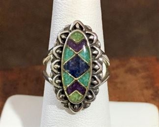 Carolyn Pollack southwestern sterling silver ring with gemstone chip inlays including gaspeite, turquoise, sugilite and lapis.  Size 6 1/2.  Face of ring is 5/8" wide by 15/16" high.  Signed with a quarter moon/R mark (for Carolyn Pollack Relios), stamped 925. $88