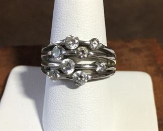 Signed sterling and CZ ring size 8 1/2. Face of ring is 7/8" wide by 1/2" high. Signed with unknown mark, stamped CZ 925. $120