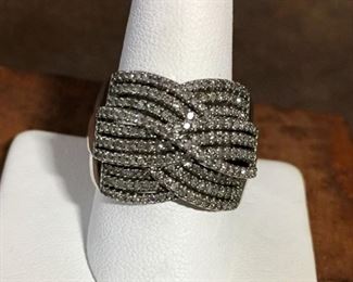 Diamond ring set in sterling silver, size 9.   Approx 1/2 carat diamond total weight. 72 round diamonds. Illusion setting gives the look of many more diamonds.  16mm wide at front of ring, tapers to 3mm in the back.   Signed SUN, stamped 925. $145