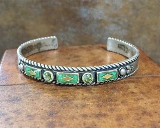 Vintage Carolyn Pollack Relios sterling silver and peridot cuff bracelet. Total circumference 6 1/2" total circumference (5 3/8" inner circumference and 1 1/8" gap). Signed with Relios logo mark, stamped .925. $165