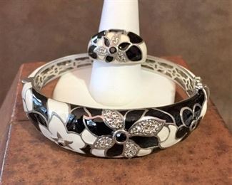 Sterling silver and enamel hinged bracelet and dome ring, each with black and clear faceted crystal accents in the flowers. Ring size 9. Bracelet inner circumference is 6 7/8". Sliding box clasp with safety latch on each side of the clasp. Each is signed EMA and stamped 925. Bracelet $140, Ring $60